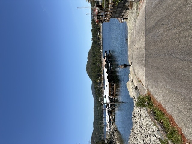 Pender Harbour marina with boats, blue sky, and forested hills